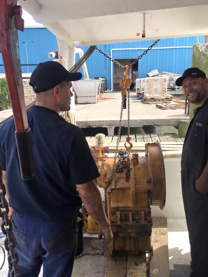 Coworkers working on an engine